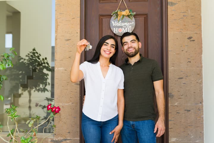 New homeowners holding the keys to their home