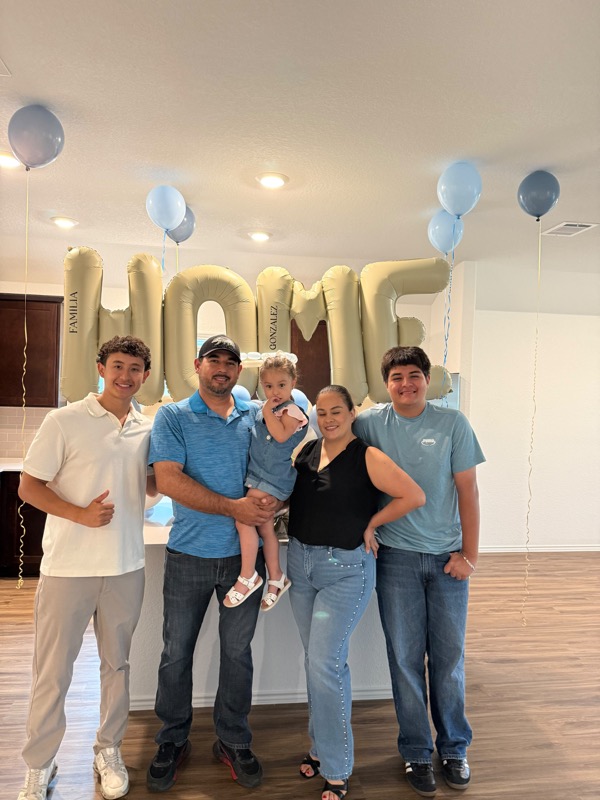 Family celebrating inside their new home